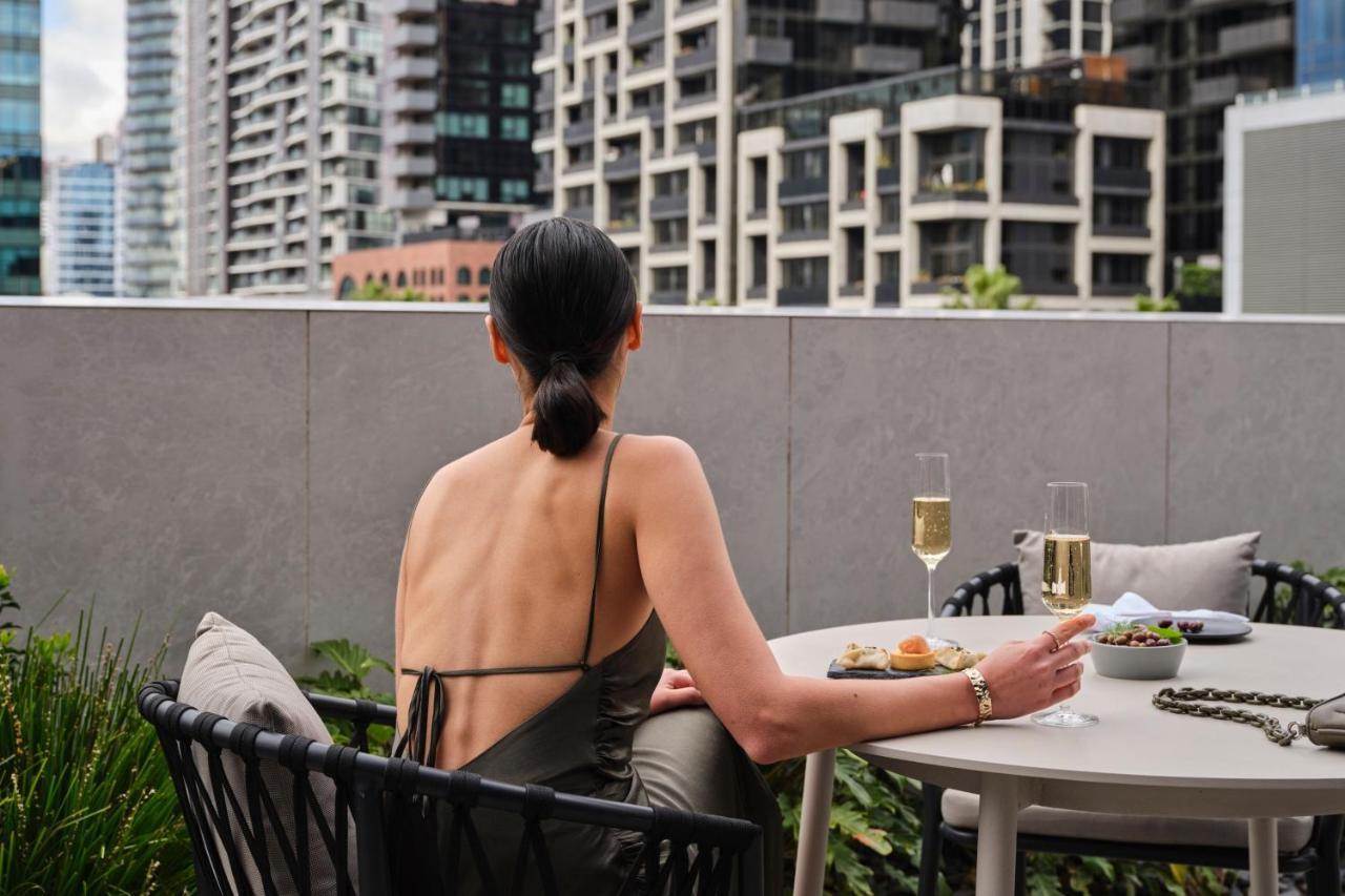 Melbourne Marriott Hotel Docklands מראה חיצוני תמונה A woman sitting on a balcony